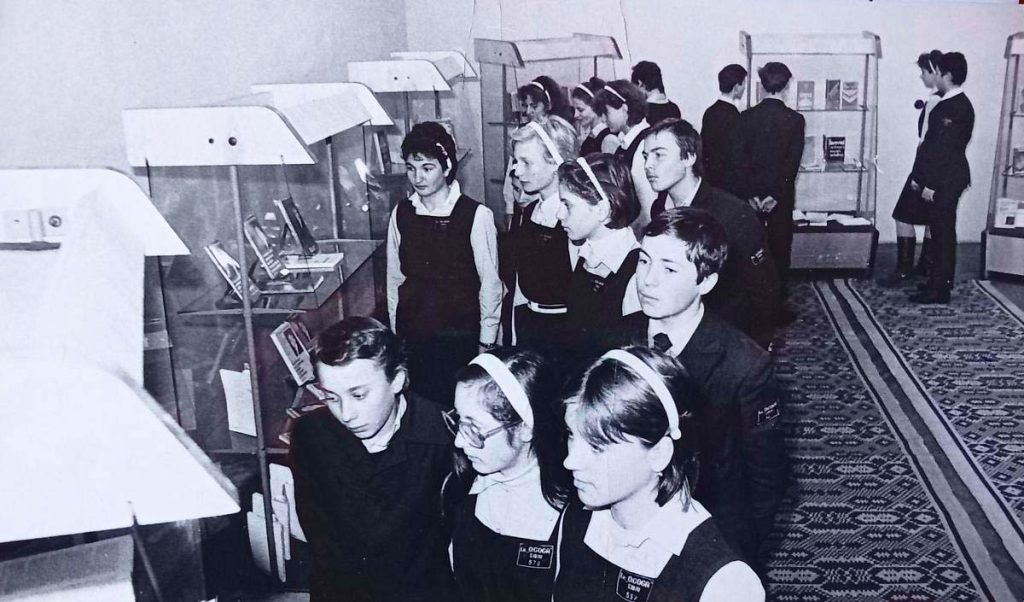 Studenti rumeni durante una visita a una mostra di libri negli ultimi anni di liceo in Romania, foto in bianco e nero degli anni ’70.